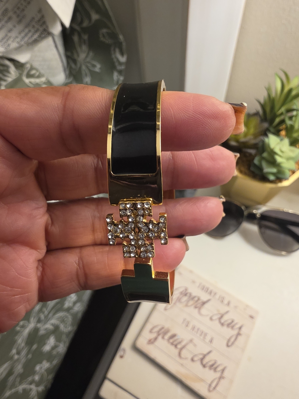 Tory Burch black and gold-tone resin cuff bracelet featuring a pavé crystal-embe